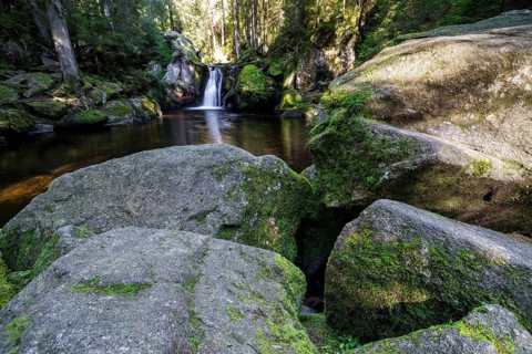 Waterfall in autumn forest with rocks