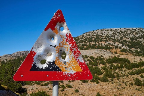 Shot triangular warning sign