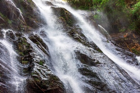 Beautiful waterfall with water flowing between the rocks and the forest in Minas Gerais