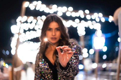 Winter lifestyle at Christmas. Brunette Caucasian girl in a fashionable dress with sequins