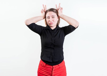 People making horns gesture with their fingers