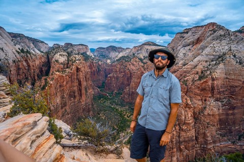 A man enjoying the views of Zion from the Angels Landing Trail in Zion National Park