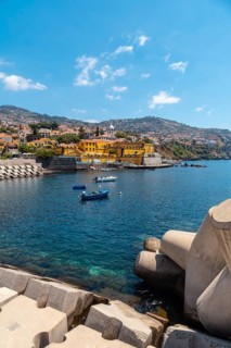 Small fishing boats next to the Forte de Sao Tiago on the beach of Funchal