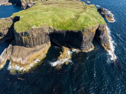 Aerial view of the uninhabited rocky island of Staffa with the prominent basalt columns and Fingal's Cave