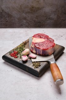 Big piece of raw beef shank cross-cut on cleaver with spice and herb