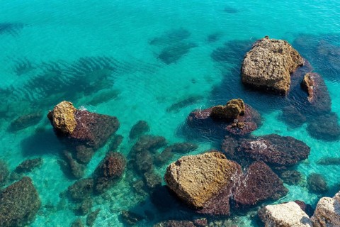 Detail of the sea and rocks on Calahonda beach in the town of Nerja