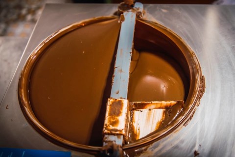 Making the liquid Natural Chocolate Cocoa circling on Roatan Island. Honduras