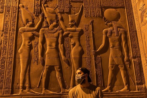A young man visiting the beautiful temple of Kom Ombo at night