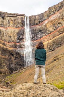 A young girl sitting in one of the wonders of Iceland
