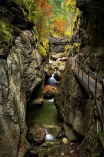 The Starzlachklamm gorge in autumn with trees in autumn leaves. The circular trail leads along rock walls