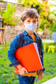 Caucasian child with face mask ready for back to school. New normality