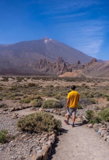 A young tourist on the volcano trekking trail at the Llano de Ucanca viewpoint in the Teide Natural Park in Tenerife