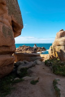A young woman looking at the sea along Lighthouse Mean Ruz