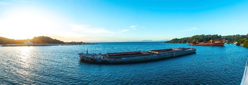 Panoramic of abandoned boat in the port of Roatan at dawn. Honduras