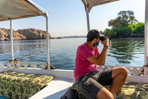 A young man on the boat that takes you to the Temple of Philae with its beautiful columns