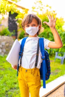 Caucasian child with face mask ready for back to school. New normality