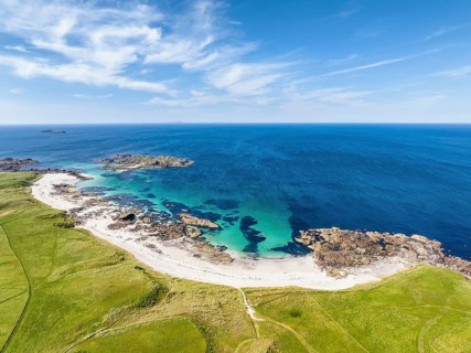 Aerial view of Traigh An T-Suidhe sandy beach on the north side of the Isle of Iona