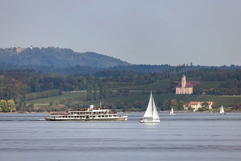 Excursion boat KARLSRUHE underway on Lake Constance against the backdrop of Birnau Monastery