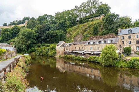 Houses and boats on the Rance river in Dinan medieval village in French Brittany