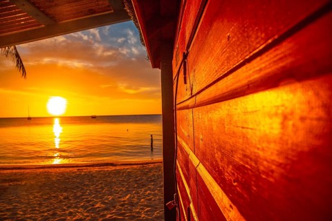A wooden house at Sunset from West End Beach