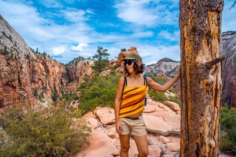 A young woman on top of the trekking of the Angels Landing Trail in Zion National Park