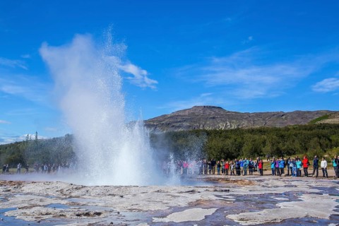 Geysir Strokkur with the sun in the background of the golden circle of the south of Iceland