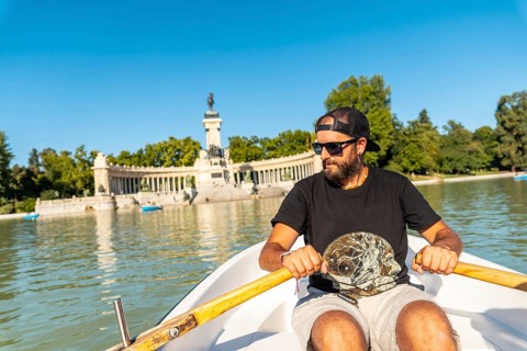 A tourist rowing the boat in the Estanque Grande de El Retiro in the city of Madrid. Spain