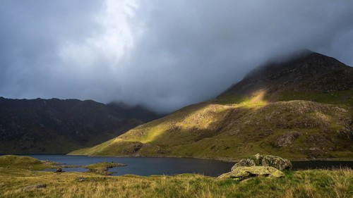 Lake Llyn Llydaw with Mount Snowdon behind clouds in late summer