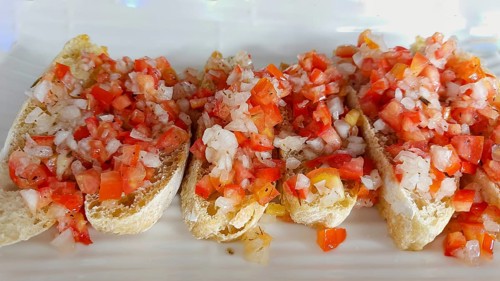 Vegan Bruschetta made from tomatoes and onions drizzled with olive oil