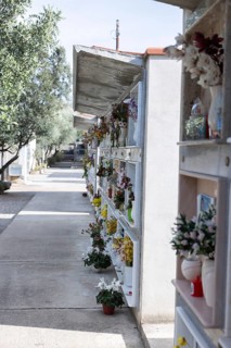 Wall with decorated urns graves in a cemetery in Sardinia