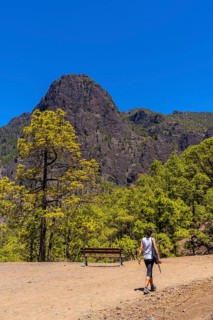 A young woman walking along the La Cumbrecita trail on the island of La Palma next to the Caldera de Taburiente
