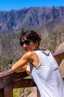 A young tourist looking at the landscape at the Mirador de los Roques on the La Cumbrecita mountain on the island of La Palma next to the Caldera de Taburiente
