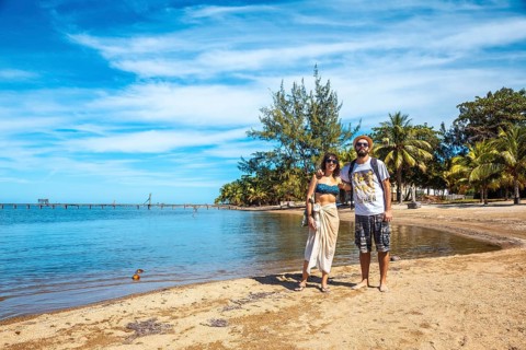 Two young men on the beach of Sandy Bay on Roatan Island. Honduras