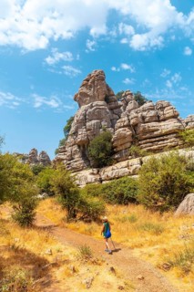 A young woman trekking enjoying the Torcal de Antequera on the green and yellow trail