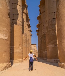 A young tourist wearing a hat visiting the Egyptian Temple of Luxor. Egypt