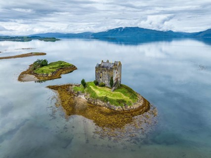 Aerial view of the 14th century island castle Castle Stalker in Loch Laich