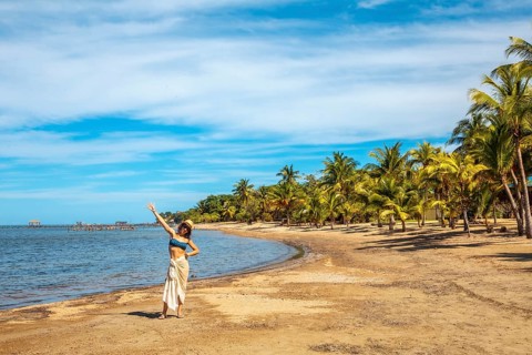 A young tourist on the beach of Sandy Bay on Roatan Island. Honduras