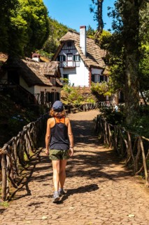A young woman walking at the start of Levada do Caldeirao Verde
