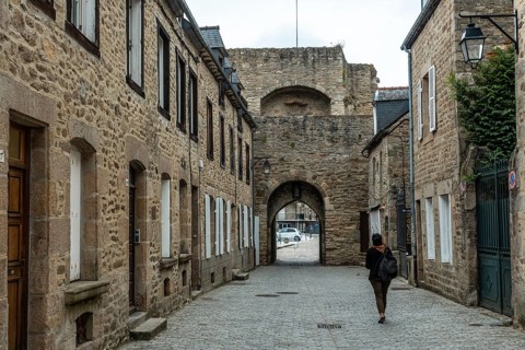 Lovely wooden houses in the old town of Dinan and its medieval castle along the Rance river in French Brittany