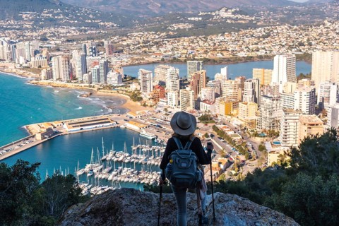 A hiker with a hat in the Penon de Ifach Natural Park in the city of Calpe
