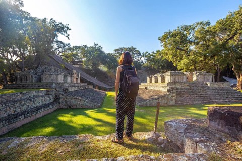 A young girl watching The ball game field in the temples of Copan Ruinas. Honduras