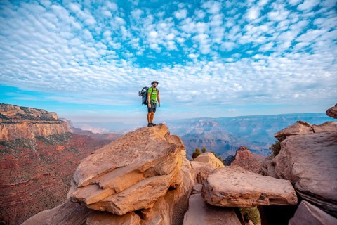 A young man on a viewpoint of the descent of the South Kaibab Trailhead. Grand Canyon