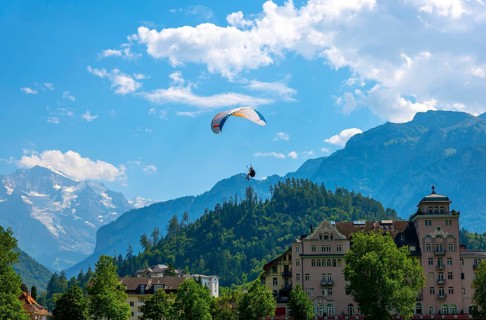Paragliding in Front Of Snow Capped Jungfraujoch Mountain in a Sunny Day in Interlaken