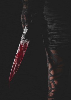 Hand with black lace glove holds bloodstained knife next to woman's leg