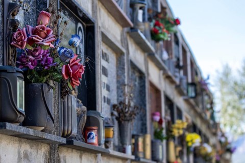 Wall with decorated urns graves in a cemetery in Sardinia