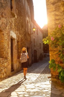 A young tourist walking in Pals medieval town