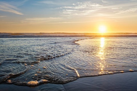 Atlantic ocean sunset with surging waves at Fonte da Telha beach