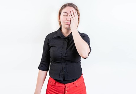 Exhausted woman with palm on forehead isolated. Tired and exhausted young girl holding her forehead. Worried young woman holding his forehead