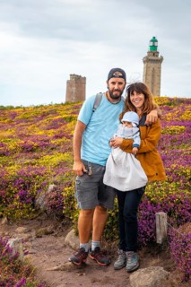 A family next to the flowers in summer in Phare Du Cap Frehel