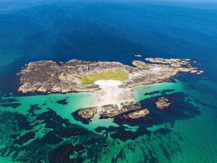 Aerial view of a deserted island with sandy beach